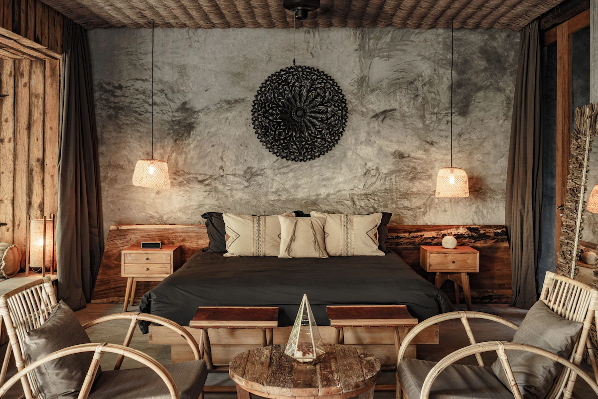 Room interior at Be Tulum hotel with concrete walls and mood lighting