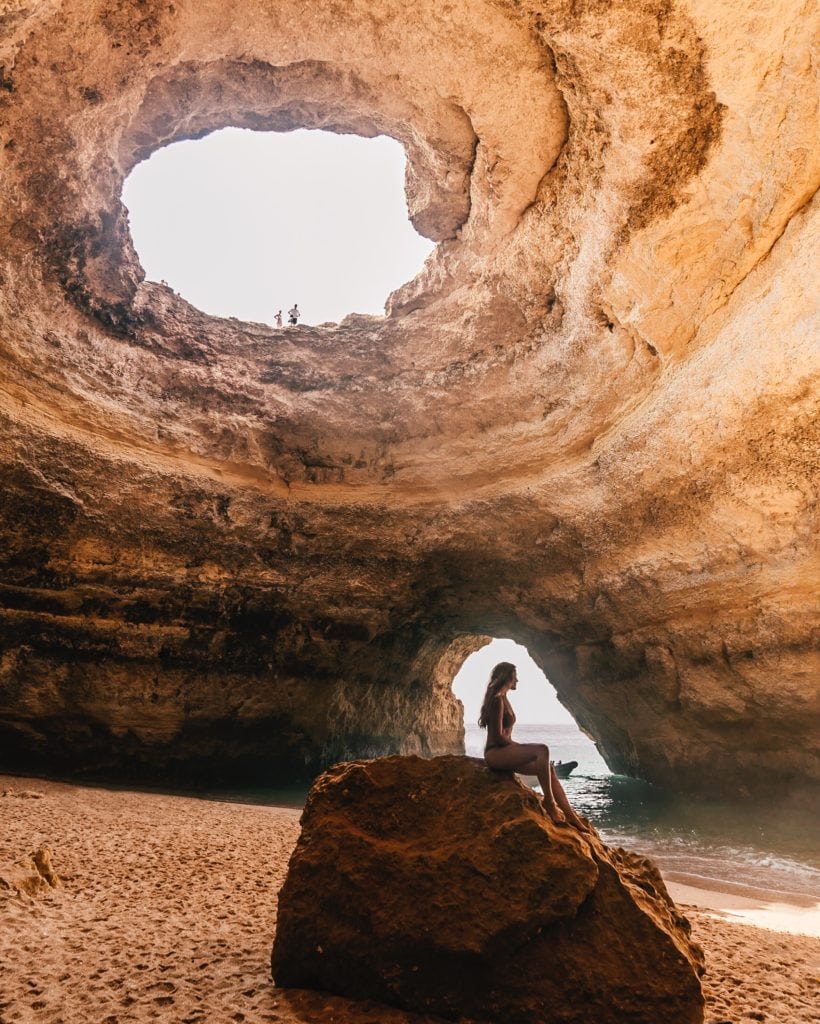 Michelle Halpern sits on a rock inside the Benagil Cave in Algarve, Portugal