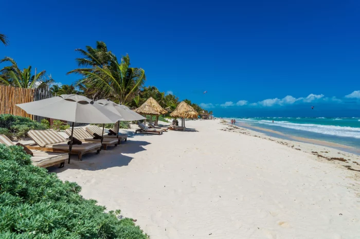 The Tulum beach in front of Casa Ganesh with beach loungers and umbrellas