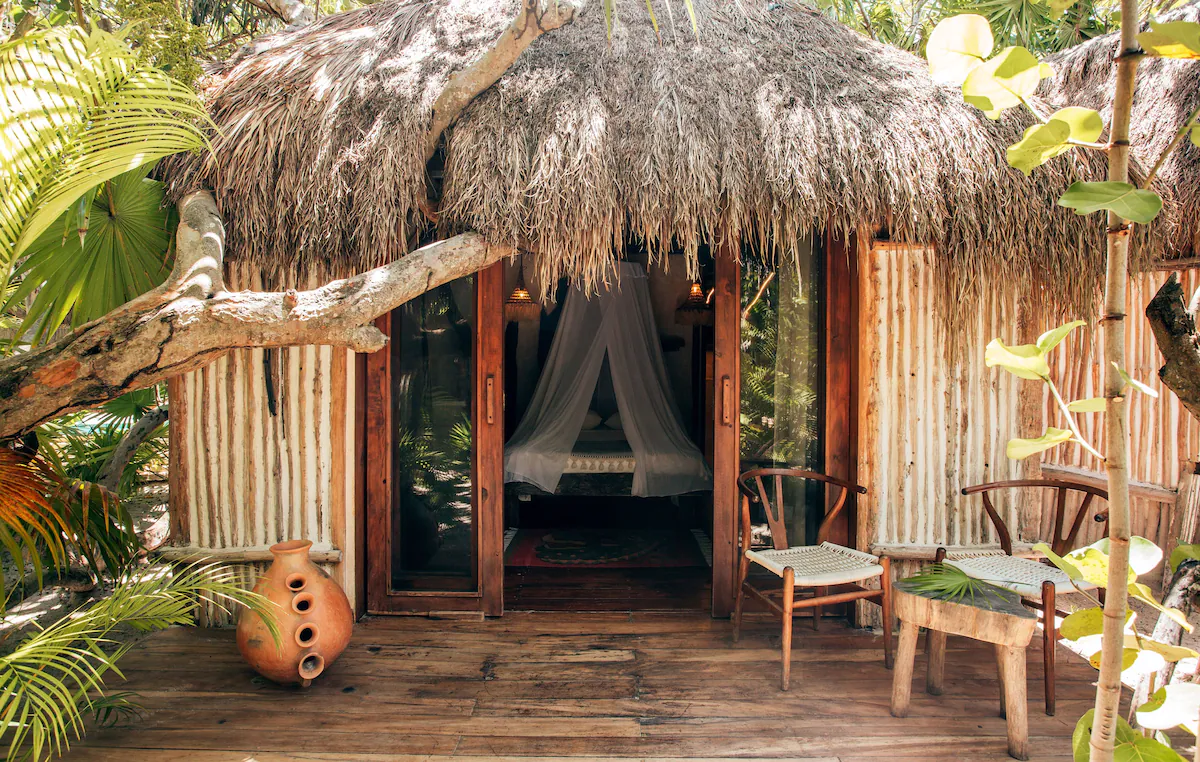 An outside peek at the guest rooms at Ikal Tulum with mosquito netting over the beds