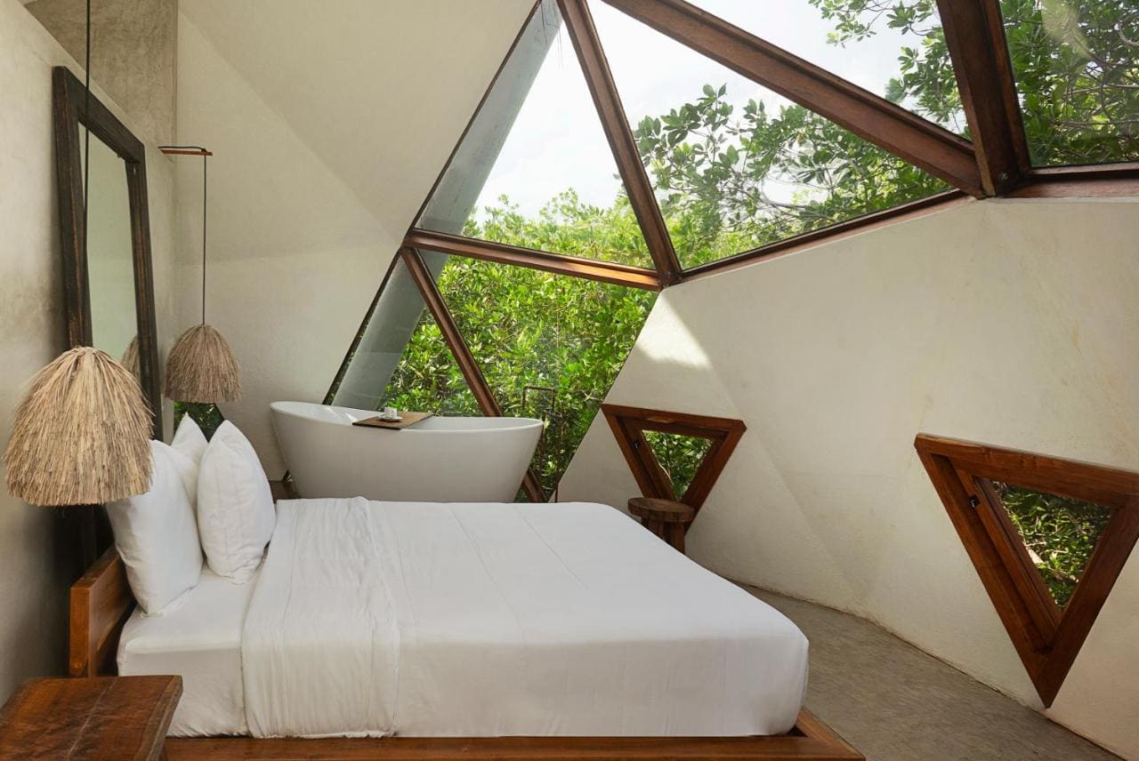 Mamasan Treehouseses and Cabins in Tulum guest room interior in all white and brown