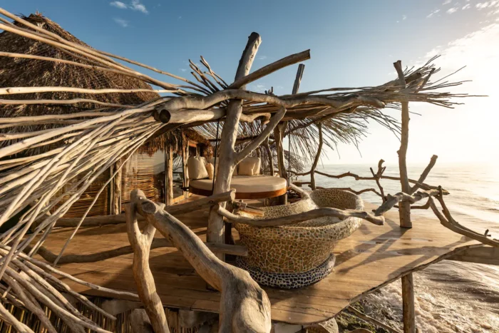 Private patio with bathtub and lounge chair at Azulik