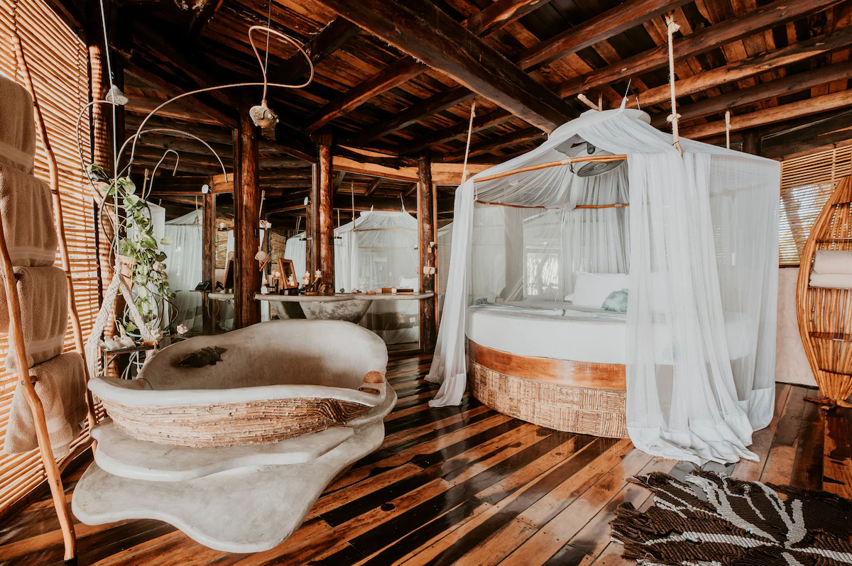 Bamboo style guest room with round bed at Azulik Tulum