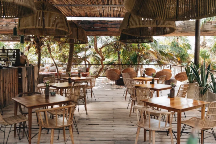 Restaurant interior with wicker and bamboo design elements at Be Tulum
