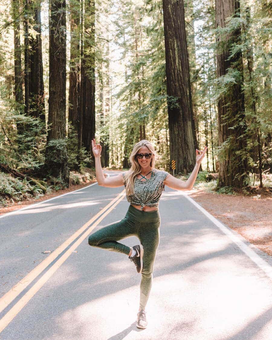 Doing tree pose along the Avenue of the Giants in California