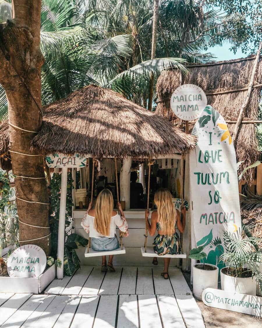 Swinging on the swings at Matcha Mama on a girls trip to Tulum, Mexico