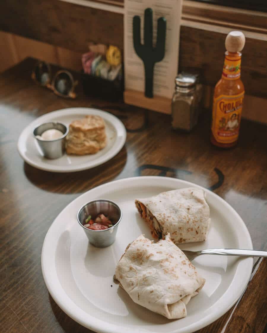 Breakfast burrito and a biscuit on the table