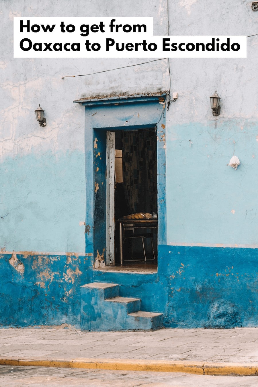 Doorway in Oaxaca with shades of crackled blue paint and text overlay