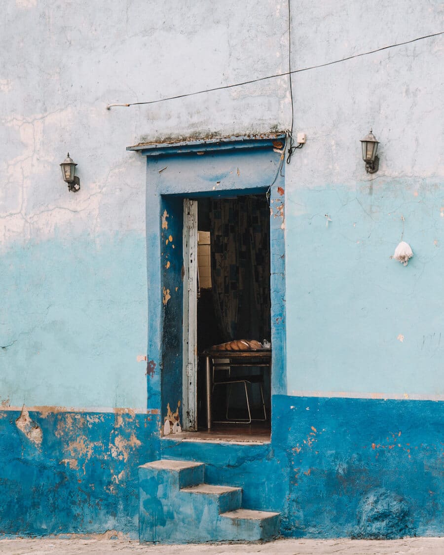 Doorway in Oaxaca with shades of crackled blue paint