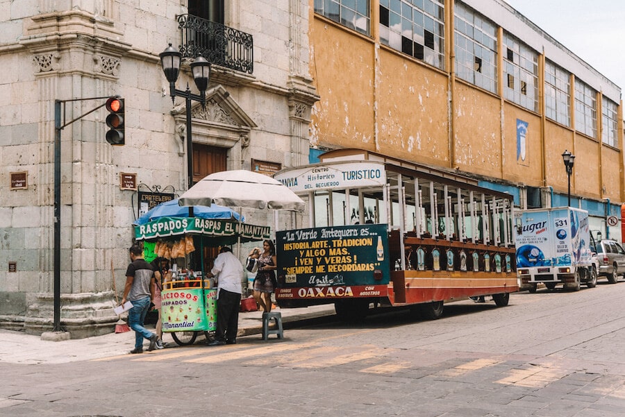 Busy street in Oaxaca City with trolley bus