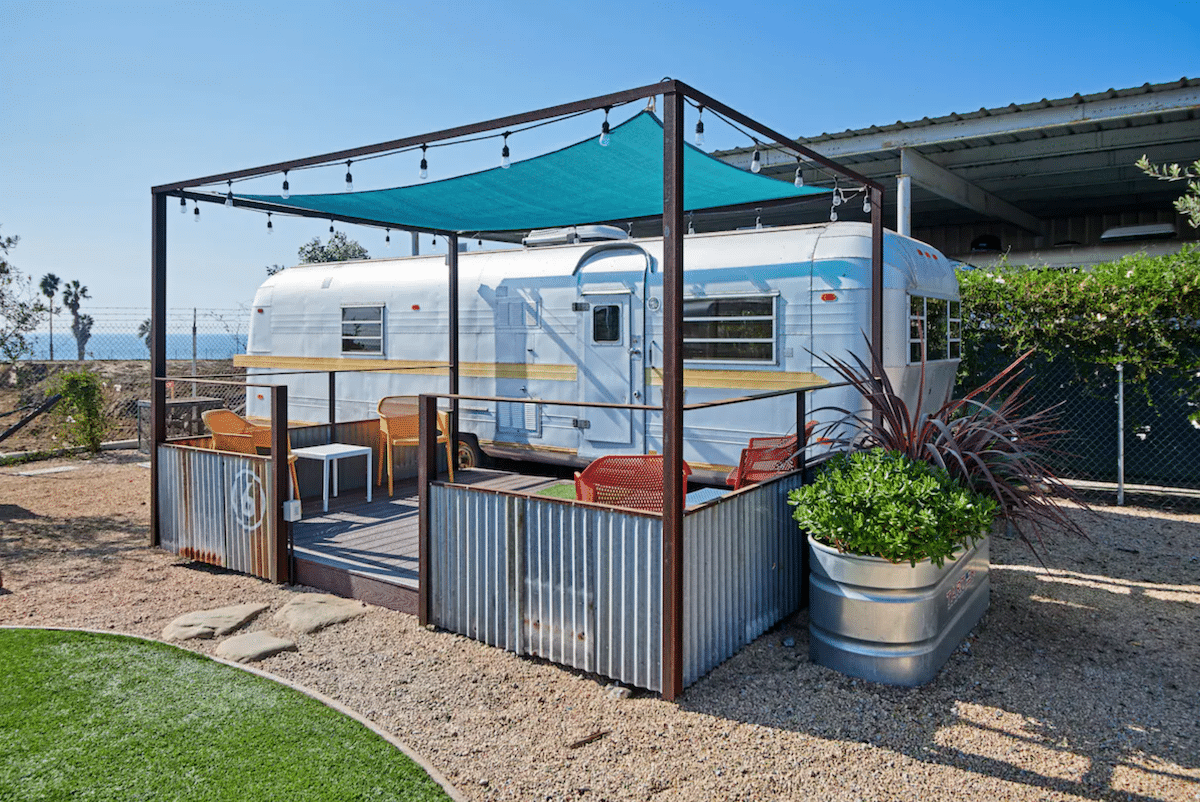 Vintage trailer with its own private patio and turquoise sun covering