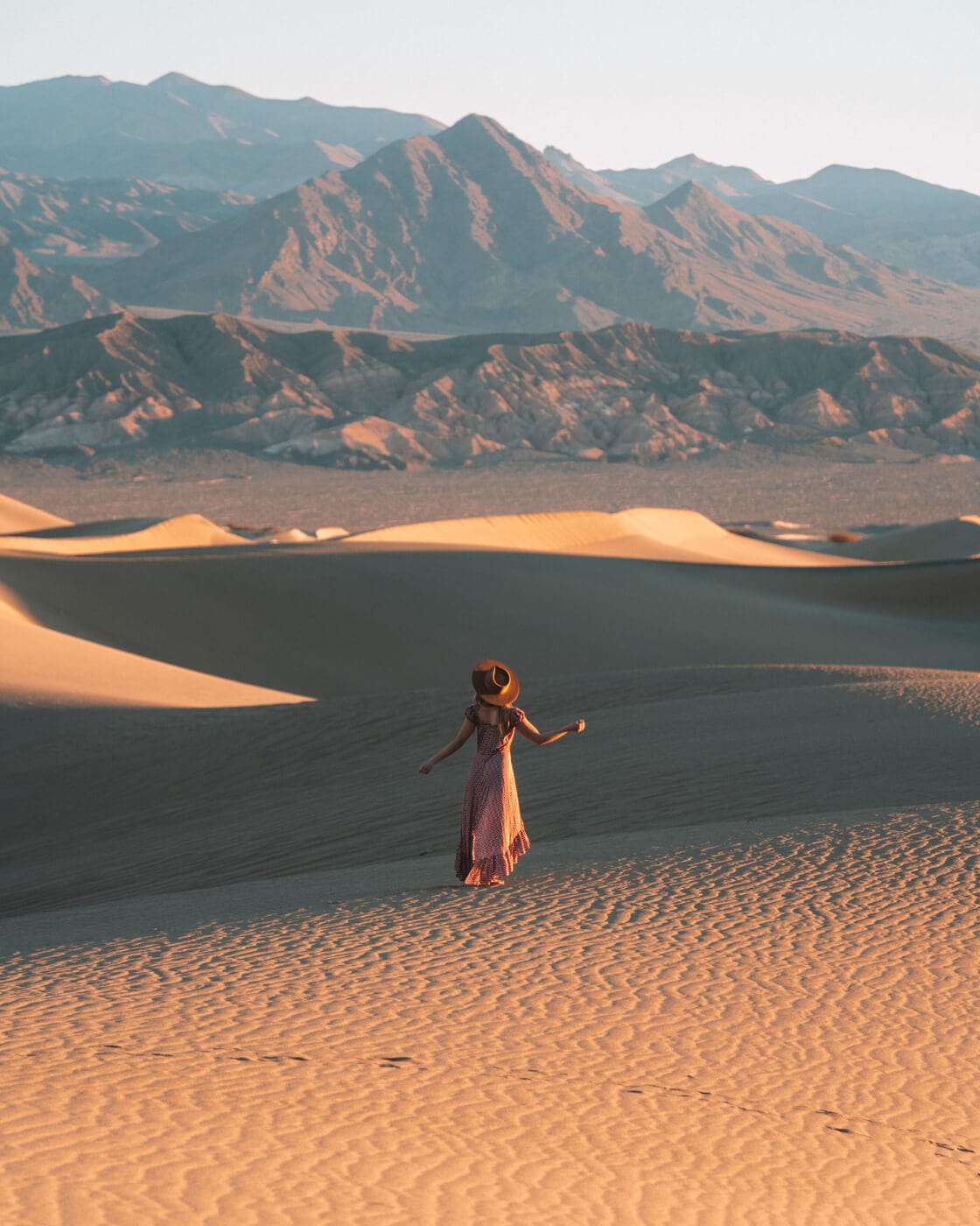 Girl standing in a dress on the Mesquite Flat Sand Dunes