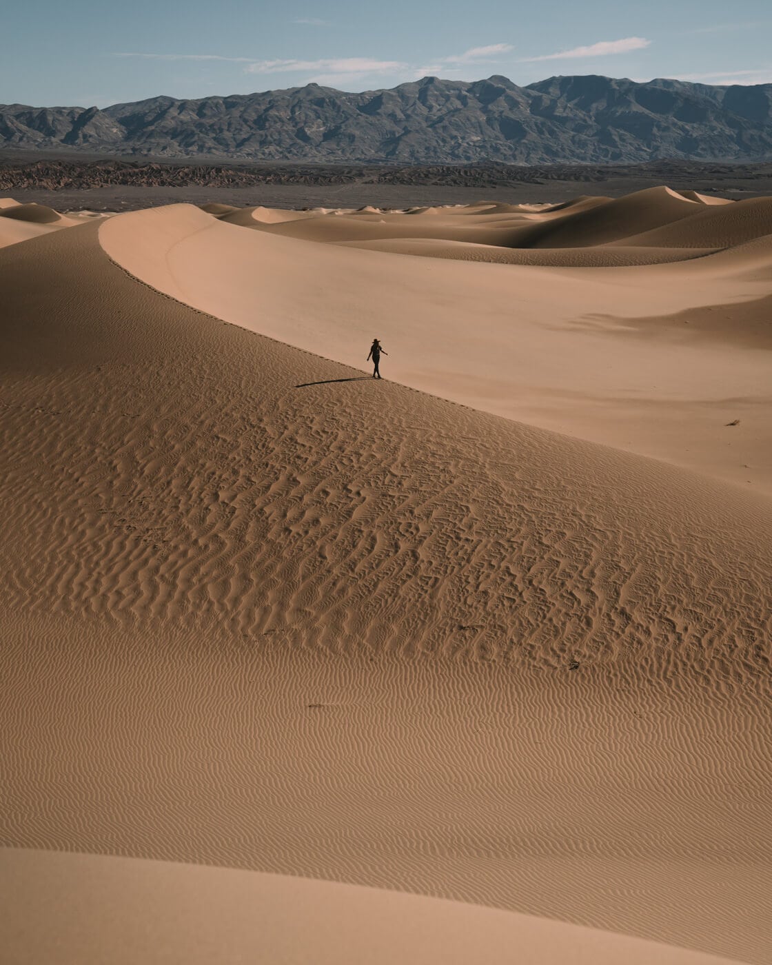 Small person walking the sand dunes in Death Valley