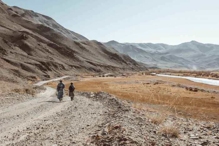 mongolia travel brochure People walking through Altai Mountains in Western Mongolia itinerary