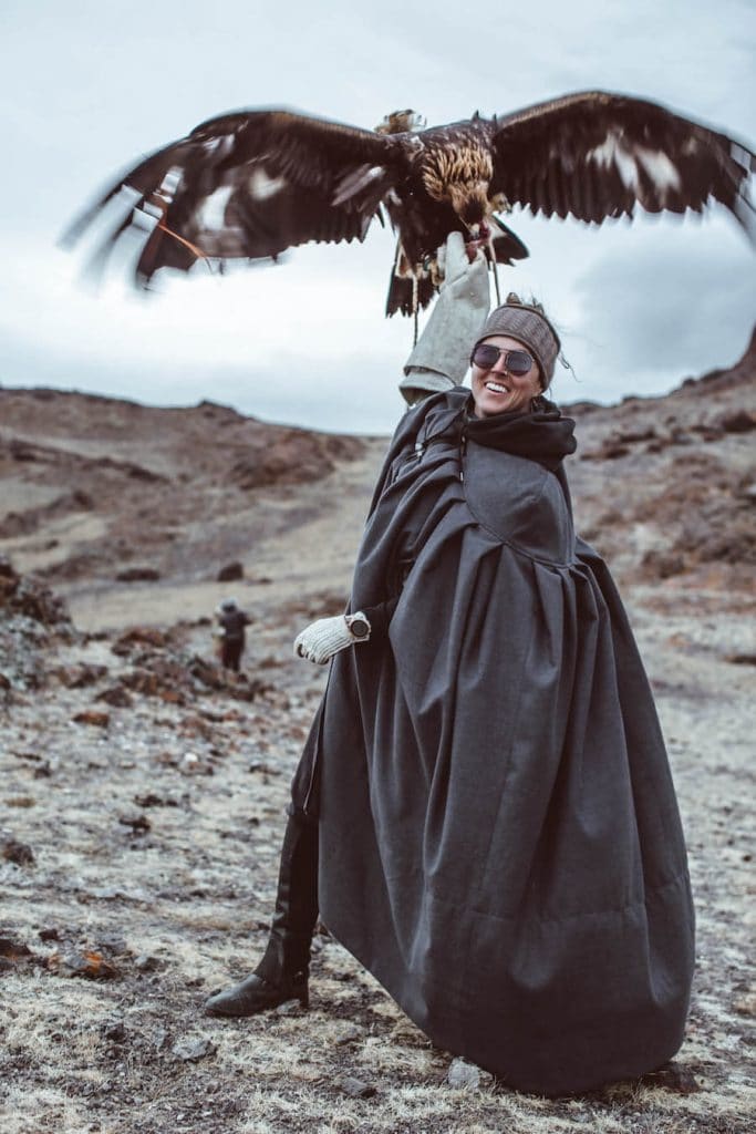 mongolia travel brochure Breanna Wilson holding an eagle in Mongolia