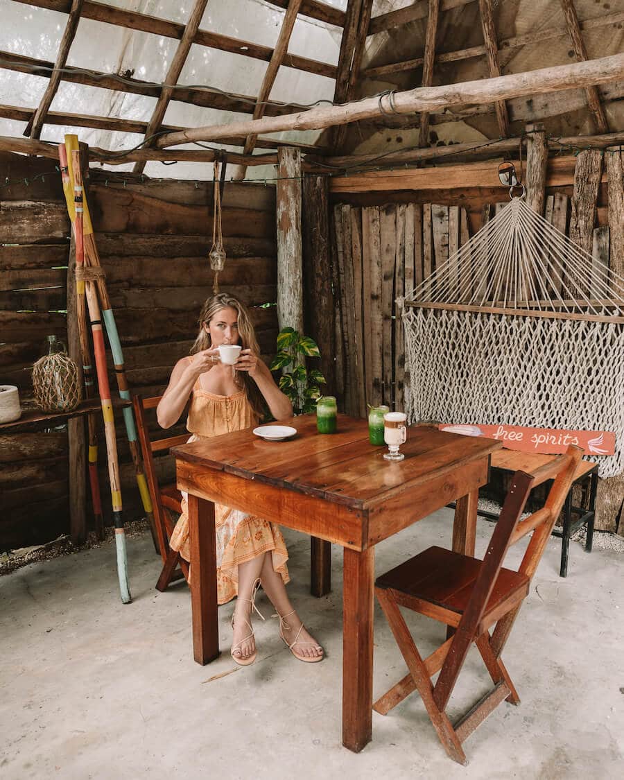 Michelle Halpern drinking coffee at a cafe in Bacalar, Mexico