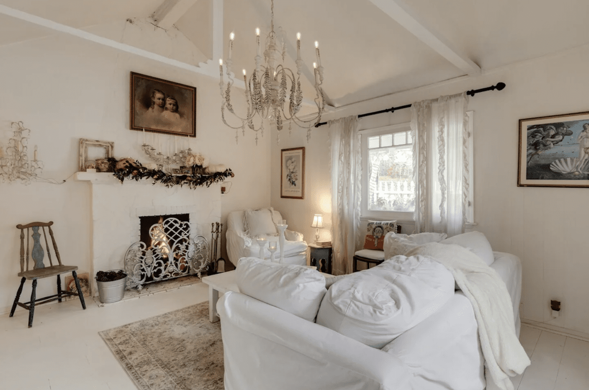White washed cottage living room in Topanga, California with fireplace 