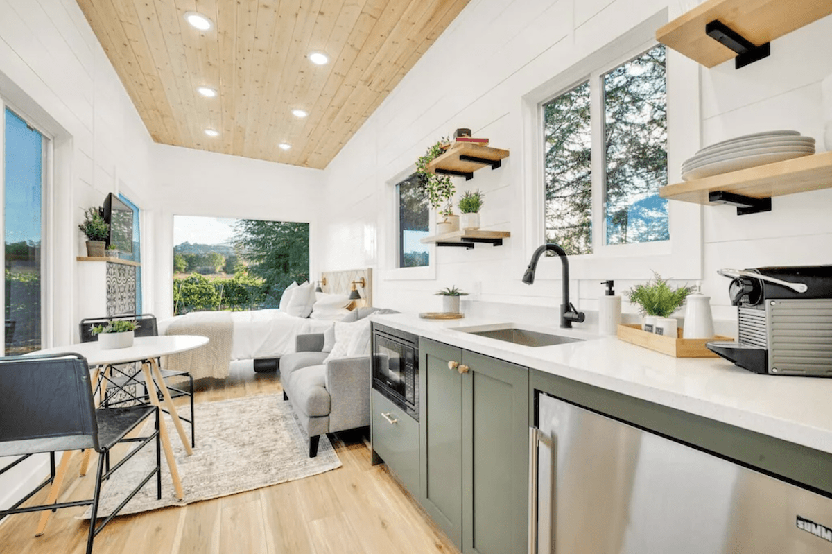 White and sage green interior of tiny home - unique places to stay in California