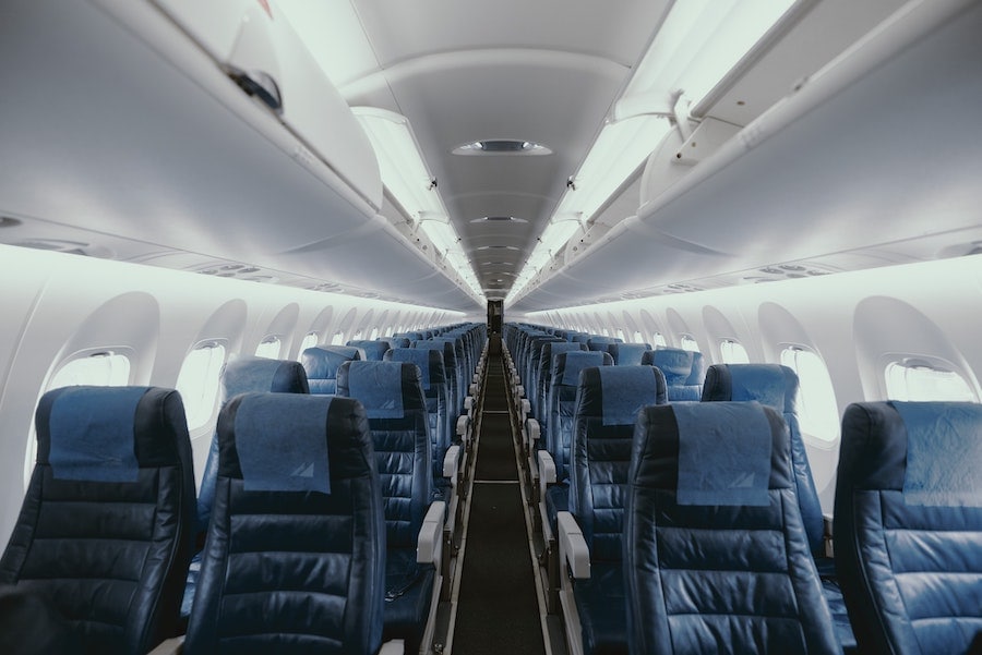 interior of airplane with rows of seats