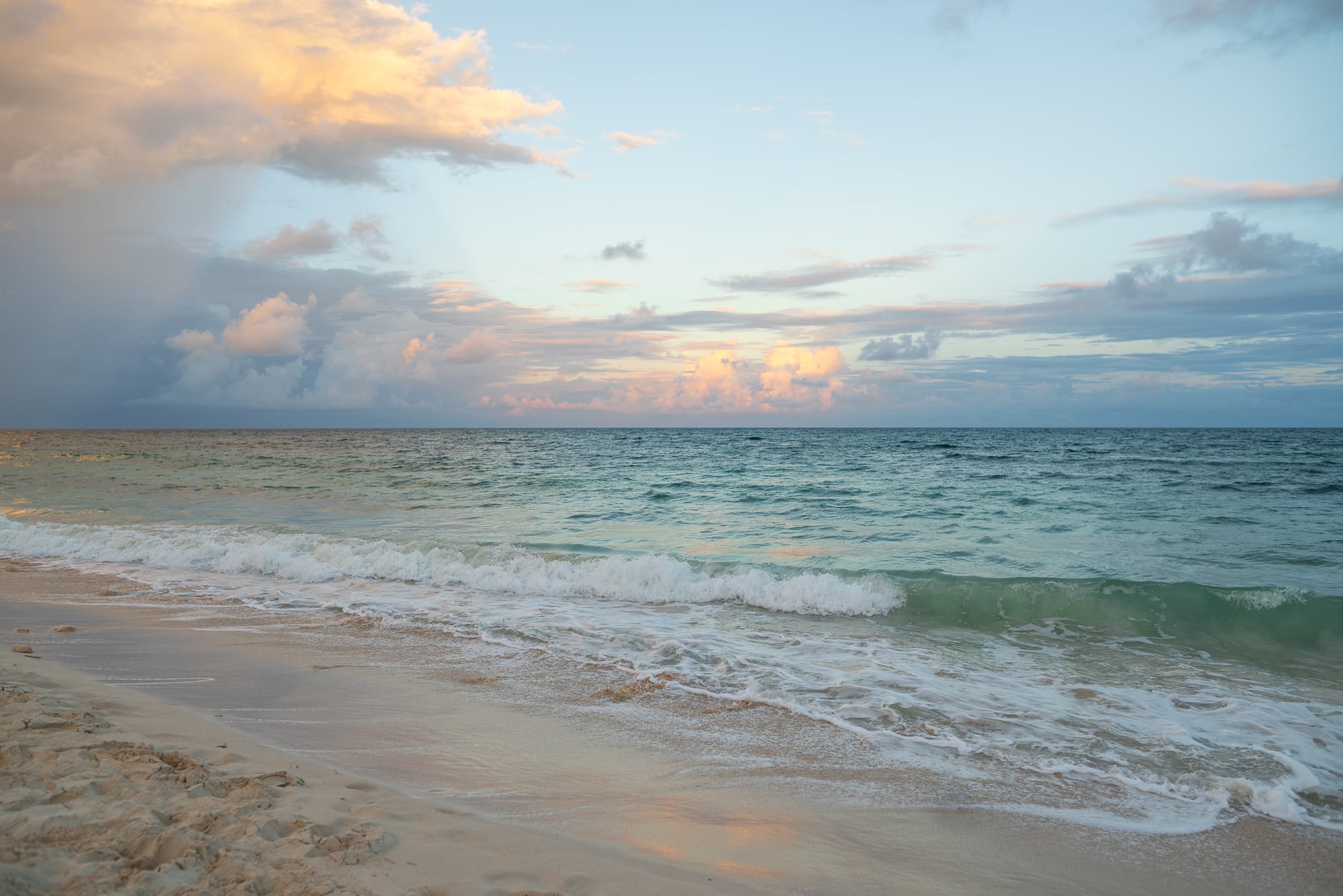 Tulum's turquoise waters at sunset