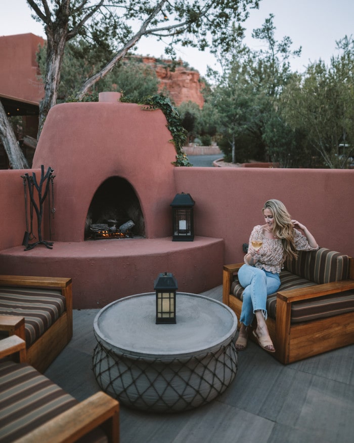 Michelle Halpern by the fireplace with a glass of wine at Enchantment Resort