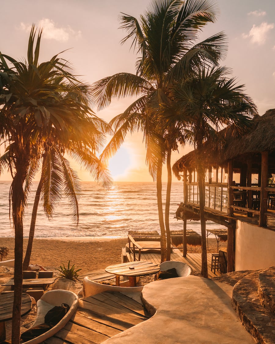 Tulum, Mexico sunset with palm trees