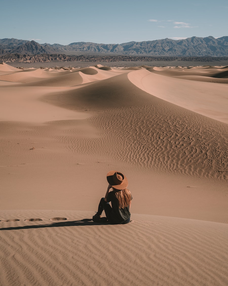 Michelle Halpern sitting on sand dune in Death Valley