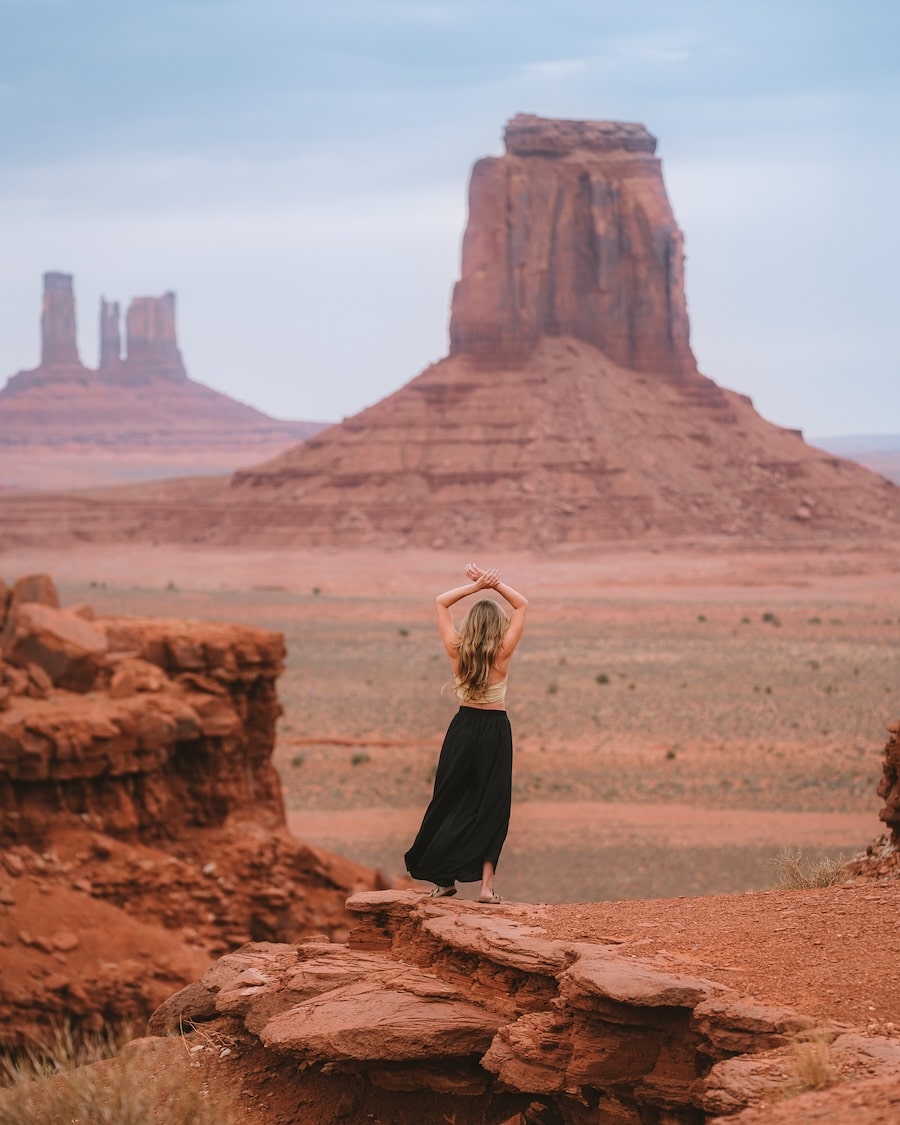 Michelle Halpern standing on a cliff in Monument Valley