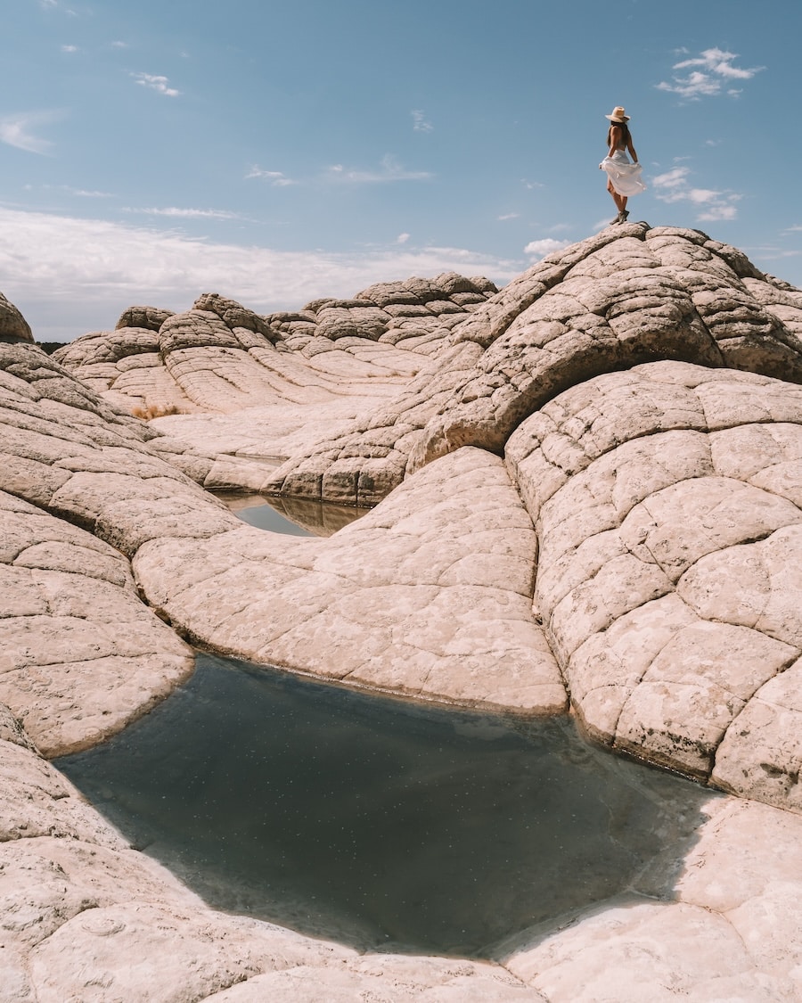 Michelle Halpern standing atop white rock formations at White Pocket in Arizona 
