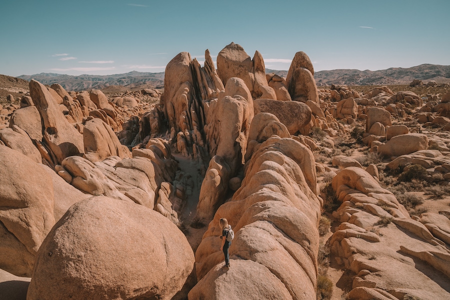 Michelle Halpern posing on rock for things to do in Joshua Tree blog