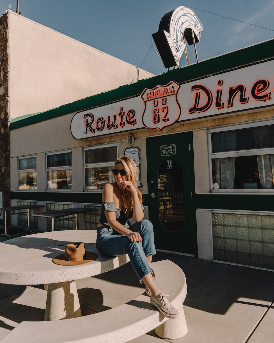 Michelle Halpern posing in front of diner for things to do in Joshua Tree blog