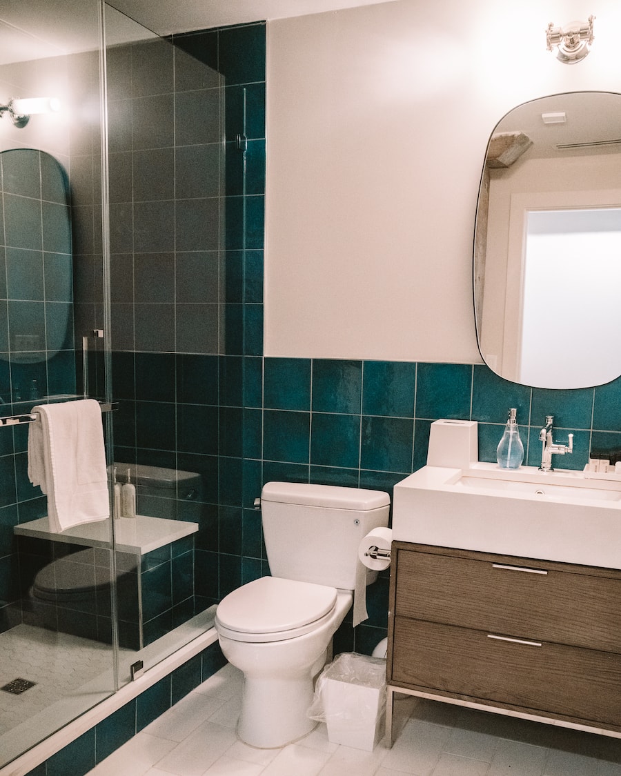 Bathroom with blue tiled wall and shower