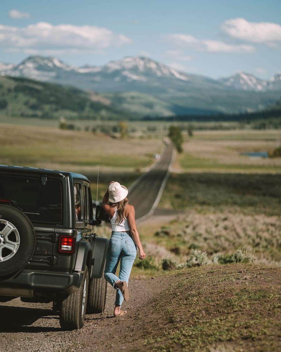Michelle Halpern posing next to Jeep for Road Trip Essentials blog