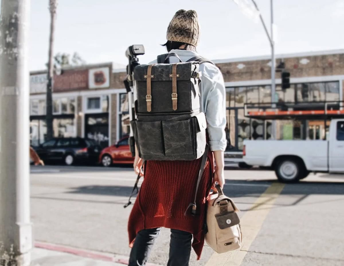Girl on street looking out at road wearing the Olliday leather backpack 