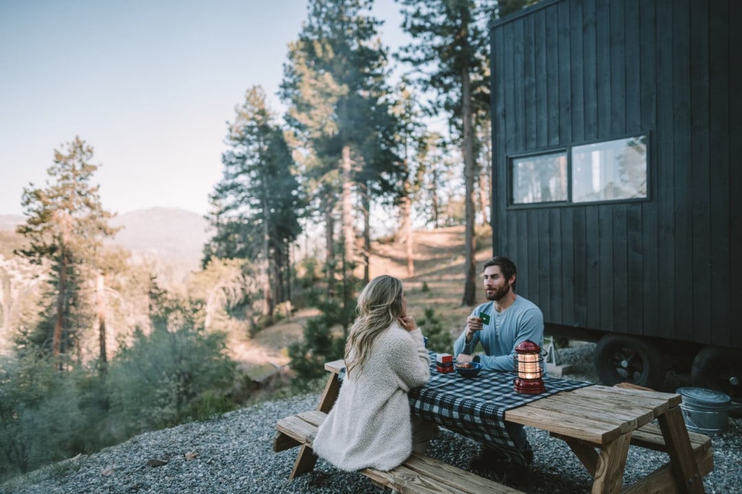 Couple doing intimacy card deck on the picnic table at Getaway House