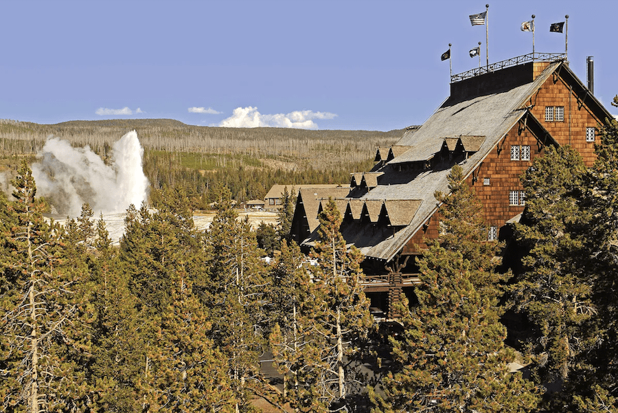 Image of Old Faithful Inn with geyser busting