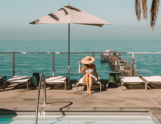 Michelle Halpern sitting on pool lounge chair on pool deck overlooking ocean