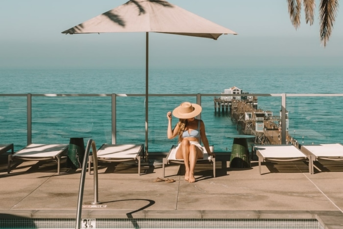 Michelle Halpern sitting on pool lounge chair on pool deck overlooking ocean