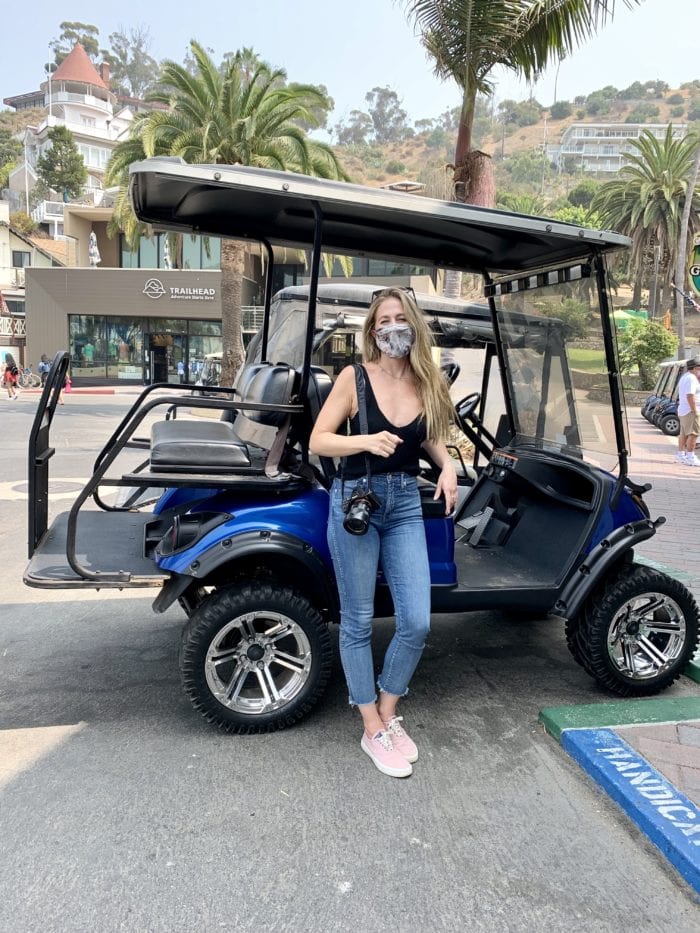 Michelle Halpern standing in front of golf cart