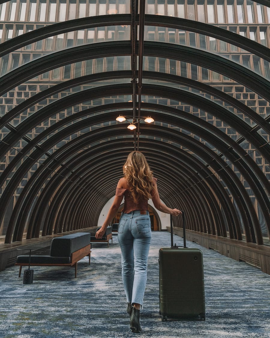 Michelle Halpern walking through a tunnel with her suitcase in Denver