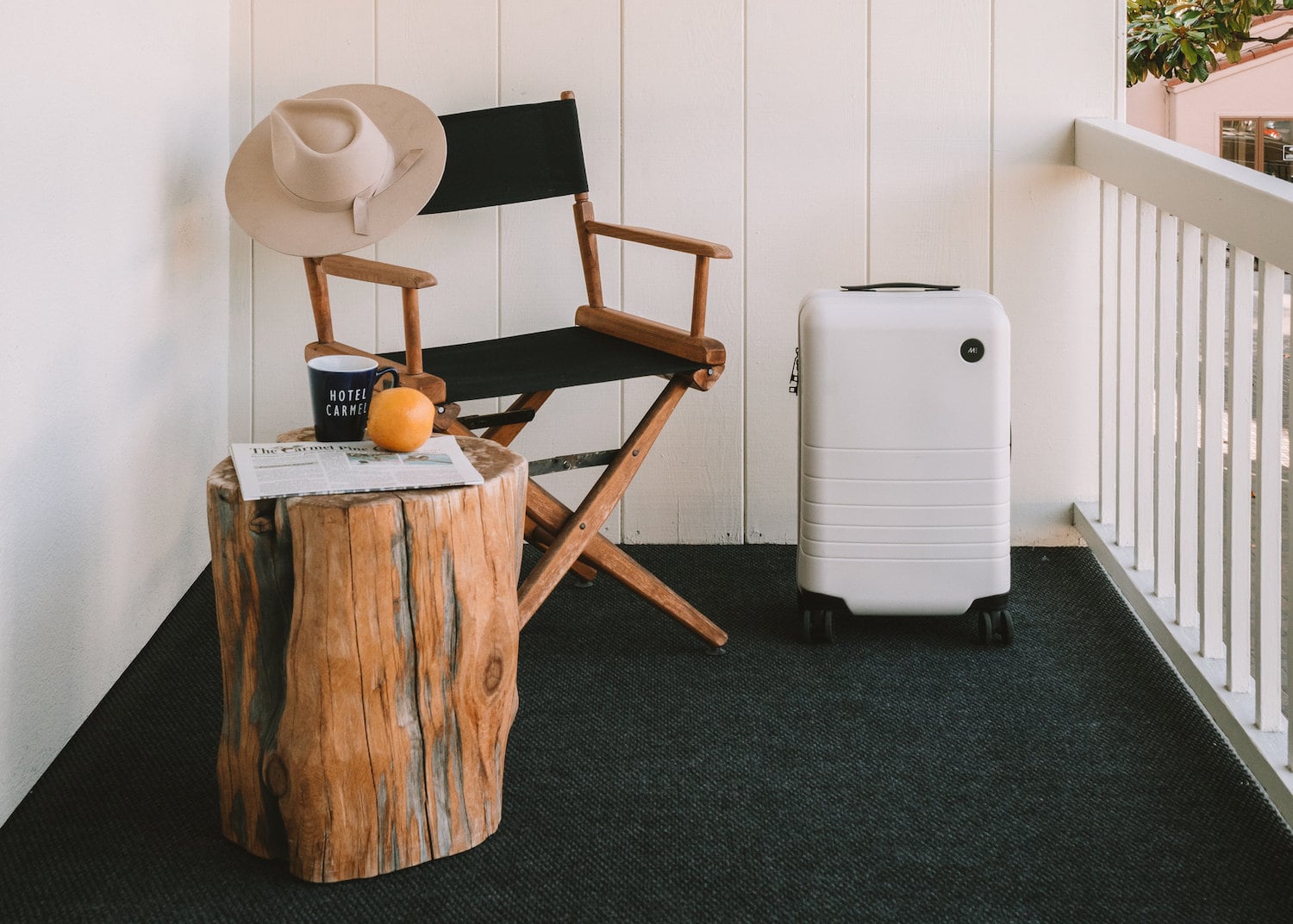 Vignette with white luggage on hotel balcony