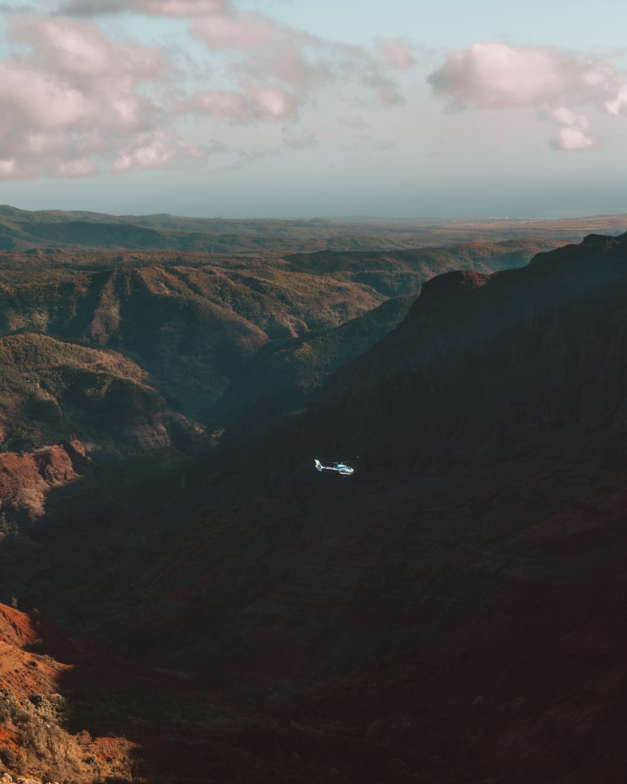 Helicopter flying inside of Waimea Canyon - travel guide to Kauai