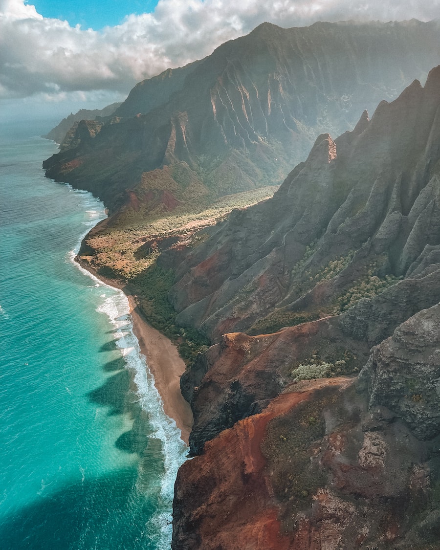 View of Kauai from above on a doors-off helicopter tour. Travel guide to Kauai