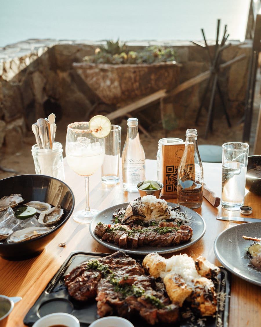 Table with many dishes from Cuatro Cuatros in Baja, California