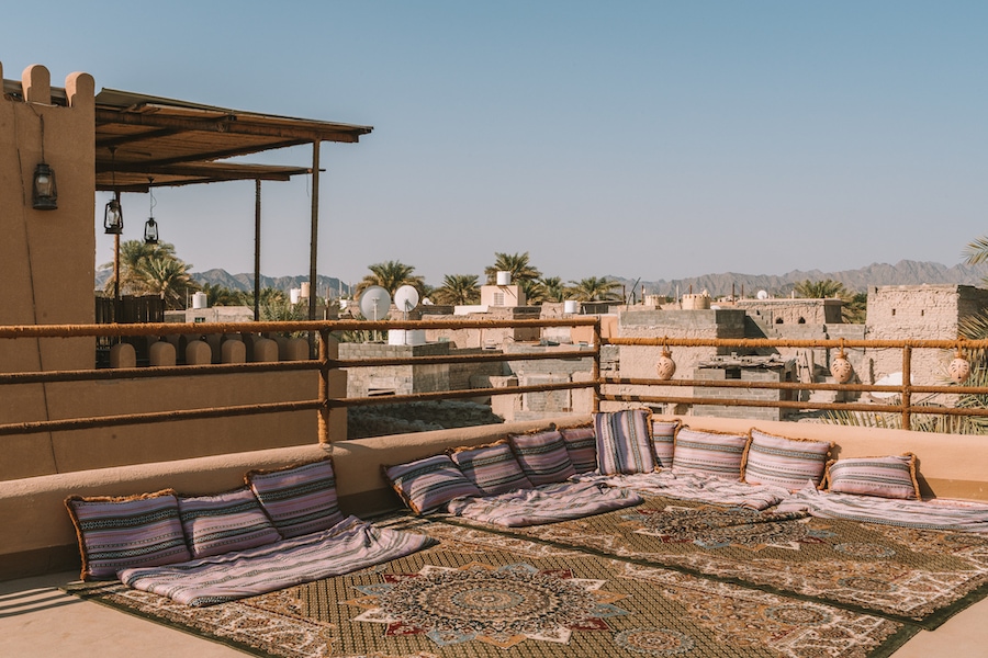 Rooftop with a rug and purple pillows at Antique Inn