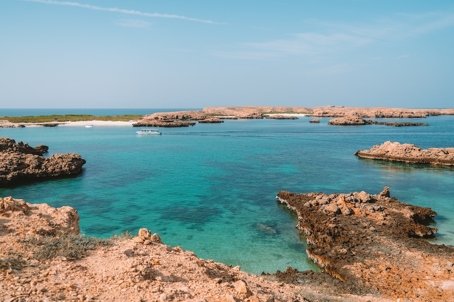 Scenic photo of the turquoise waters and coral reefs off the coast of Oman