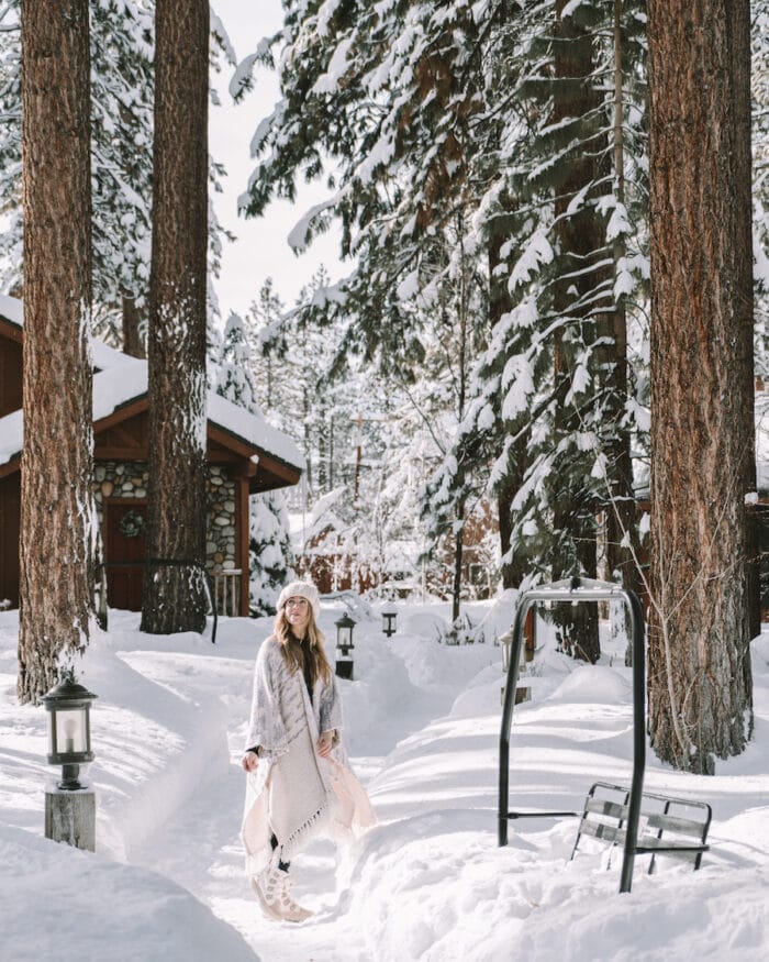 Michelle Halpern standing on a snowy path at Black Bear Lodge in South Lake Tahoe - Lake Tahoe winter guide