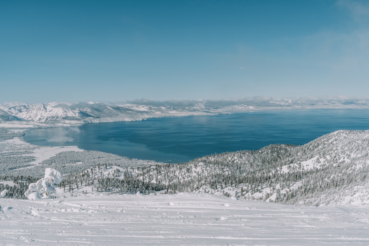 View of Lake Tahoe next to snow-capped peaks from Heavenly Mountain Resort