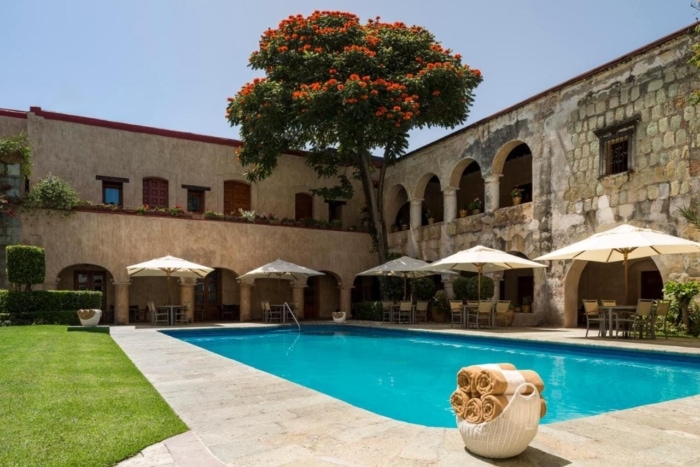 Pool area with white umbrellas at the Quinta Real Oaxaca