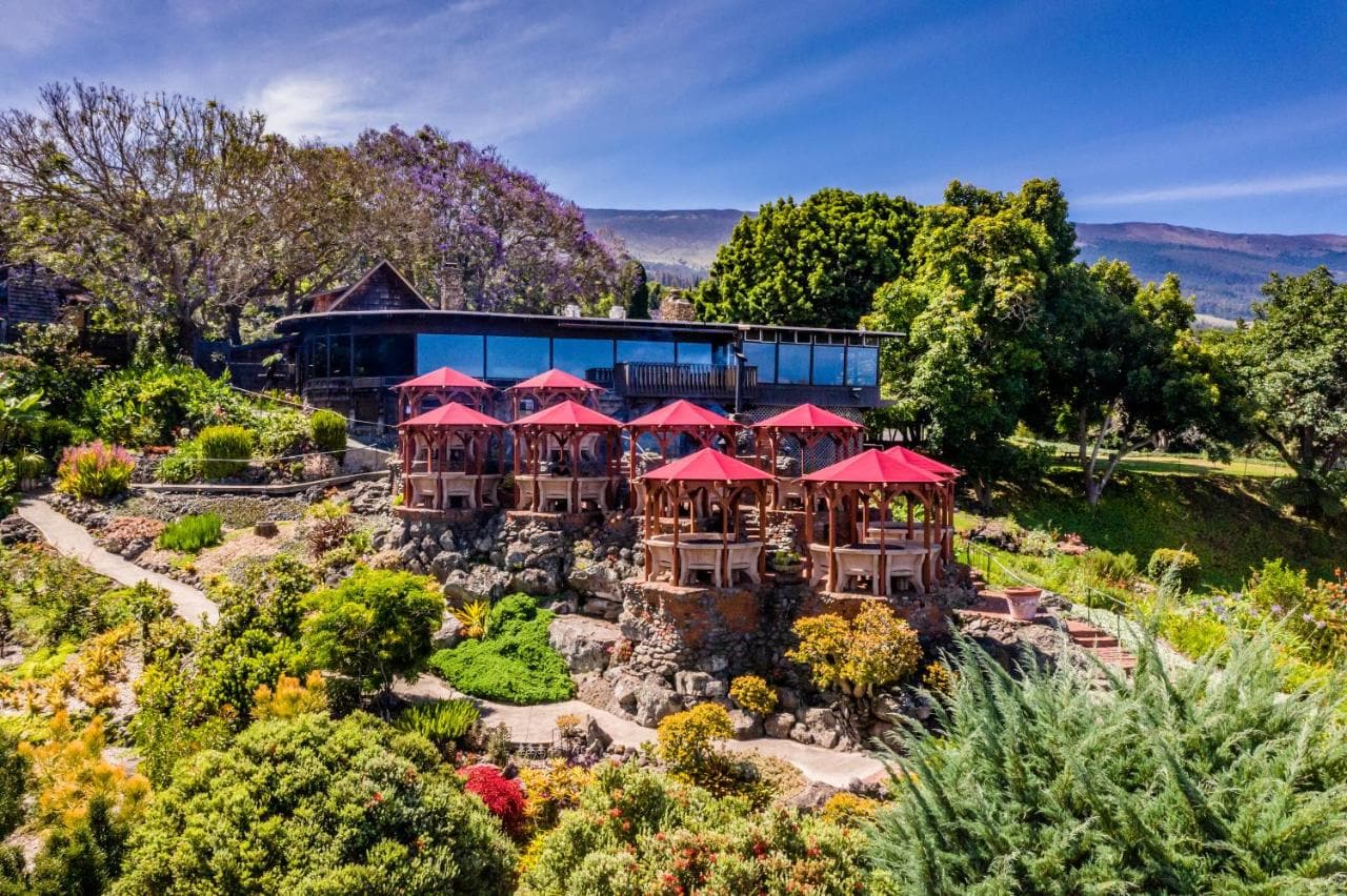 Kula Restaurant perched up on a hill with red umbrellas on the tables